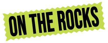 ROCKS üzerinde yeşil-siyah zig-zag mühür işareti üzerine yazılmış metin.