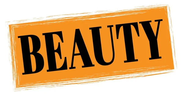stock image BEAUTY text written on orange-black rectangle stamp sign.