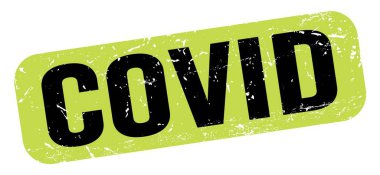 COVID text written on green-black grungy stamp sign.