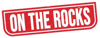 ON THE ROCKS text written on red grungy stamp sign.