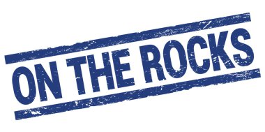ON THE ROCKS text written on blue rectangle stamp sign.