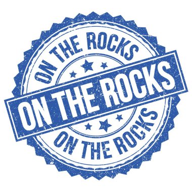 ON THE ROCKS text written on blue round stamp sign