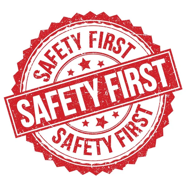 อความ Safety First ยนบนเคร องหมายสแตมป กลมส แดง รูปภาพสต็อก