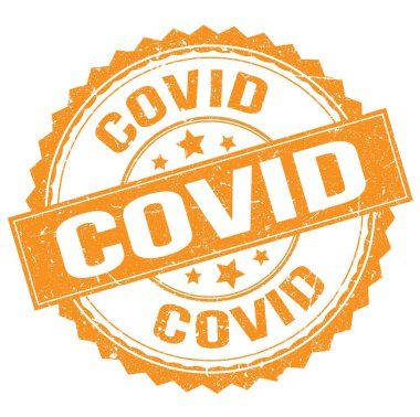 COVID text written on orange round stamp sign