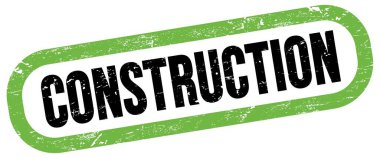 KONSTRUCTION, yeşil-siyah dikdörtgen işareti üzerine metin.