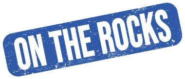 ROCKS üzerinde mavi grungy mühür işareti üzerine yazılmış metin.