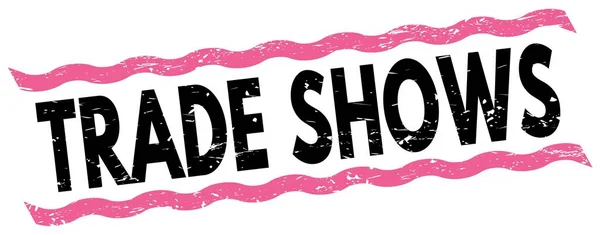 Stock image TRADE SHOWS text written on pink-black lines stamp sign.