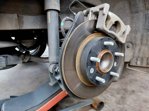 Disc brake of the vehicle for repair, in process of new tire replacement. Take off wheel for maintenance in garage , disc brake