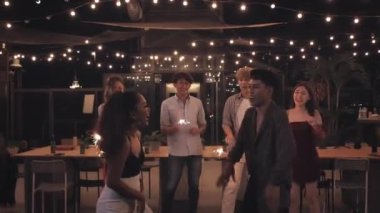 Bir grup arkadaş çatı katında ve restoranda eğleniyor.