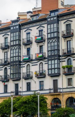 Bilbao, Spain - July 1, 2024 - buidings with Palestinian flags in Casco Viejo clipart