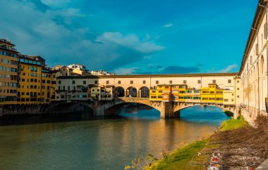 The stunning Ponte Vecchio (Old Bridge) in Florence, Italy at sunset clipart