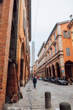 Bologna, Italy - December 15, 2024 - street view of the Asinelli Tower on a foggy day clipart