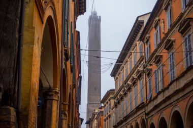 Bologna, Italy - December 15, 2024 - street view of the Asinelli Tower on a foggy day clipart