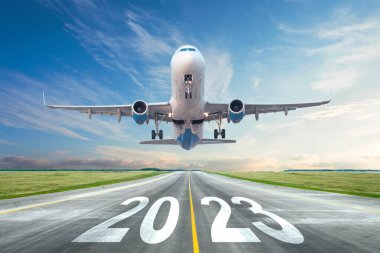 Inscription on the runway 2023 surface of the airport road yellow line take off airplane. Concept of travel in the new year, holidays clipart