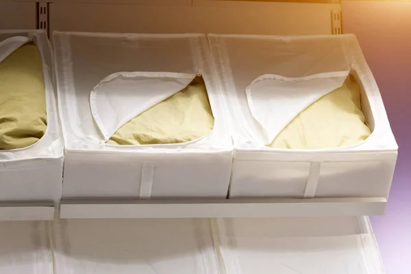 Pillows are in boxes with a zipper for storing bed linen
