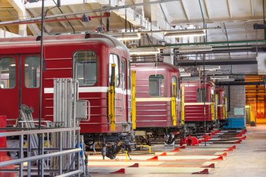 Passenger train subway cars are lined up in a row at the repair maintenance in the railway depot