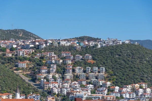 stock image Majestic panoramic view of seaside resort city of Kas in Turkey. Hillside with traditional houses in the city, Villas and hotels with red roofs are open for tourists