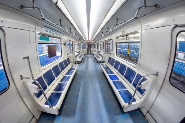 stock image Modern subway metro train inside interior, empty public transport with blue seats. Wagon with open doors in the depot