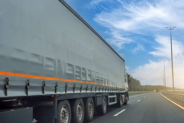 stock image Truck long tilt curtain side trailer transportation on the road day blue sky