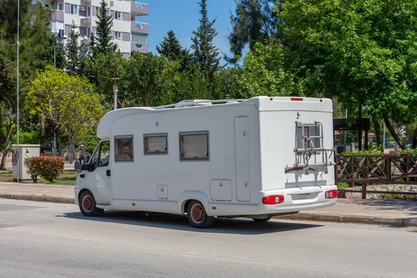Mobile home on wheels van parked in the street of the city on the side of the road