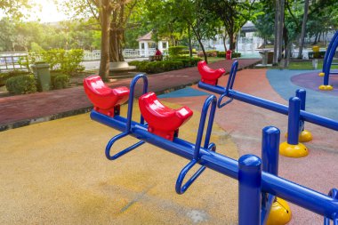 Parktaki çocuklar için tahterevalli mavisi kırmızı oyuncak.