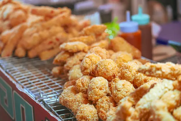 Meat snacks deep fried wings chicken legs on a street food stand
