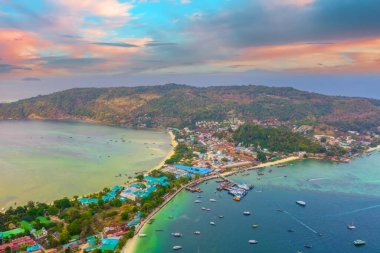 Seyahat tatil beldeleri, adaların yukarısında gün doğumunda hava ve tropik tatil beldelerinin sahillerinde, tekneleri ve gemileri olan otel evleri..