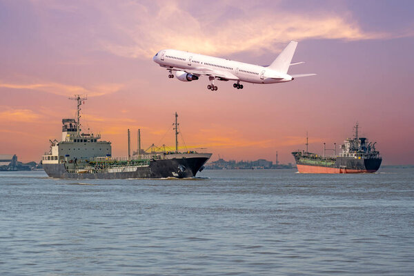 Cargo freight ships and passenger plane landing take off airport in transport for logistic sunset sky.