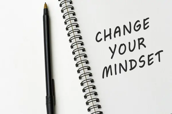 Motivational and inspirational quote on notepad - Change your mindset.