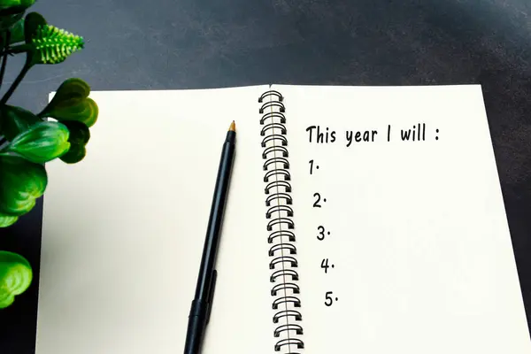 This year i will list written on notepad. New year goals concept.