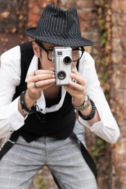 Film director videotaping with obsolete 8mm video camera.