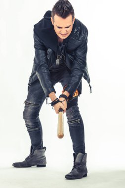 Rebellious man using baseball bat on white background. 