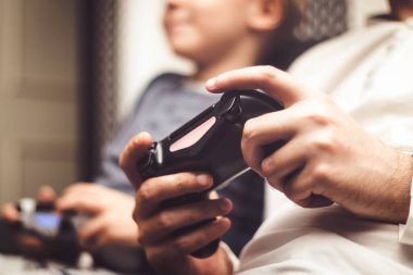 Close up of playing video game with wireless game controller.