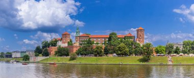 Vistula nehri Wawel Hill 'deki Krakov kraliyet sarayının altından akar ve güneşli bir öğleden sonra geçirir.. 