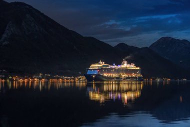 Kotor, Montenegro - September 17 2024: Cruise ship Mein Schiff is arriving to the Bay of Kotor at early morning before sunrise. clipart