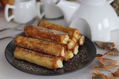 Lezzetli Fransız tostu. Ortasında tatlı süzme peynir olan tatlı bir kahvaltı. Geleneksel yumurtalı ekmek çeşitleri. Kahvaltı ve sabah aşermeleri için ev yapımı tatlar.