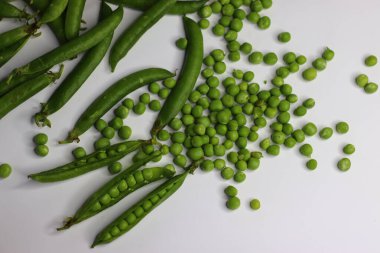 Bunch of green pea pods with open pods and scattered peas. Showcasing fresh, organic produce. Good for food blogs, recipes, and healthy eating content. Highlighting farm fresh vegetables and nutrition clipart