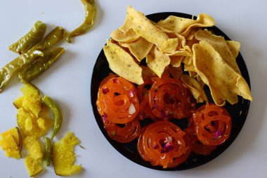 Jalebi with fafda, a beloved combination from Gujarat, India. This sweet and savory duo is a cultural symbol, enjoyed during festivals and celebrations. Perfect for food blogs, and cultural content clipart