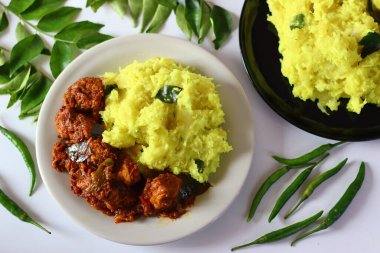 Kaynatılmış ve ezilmiş tapyoka zengin ve baharatlı tavuk körili, aromatik baharatlarla servis edilir. Doku ve rengi vurgulamak için bir açı yakalamış. Gıda blogları ve restoran menüleri için ideal
