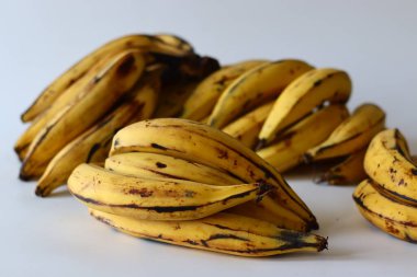 Kerala Plantains. Altın sarısı derili ve koyu benekli olgun bir grup Nendran muzu. Zengin lezzeti ve sert dokusuyla bilinir. Etakka veya vazhakka olarak da adlandırılan tropik bir Güney Hint meyvesi.