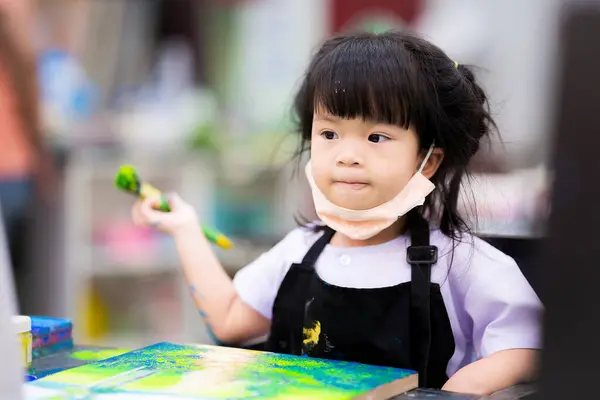Azjatycka Dziewczynka Siedzi Trzymając Duży Pędzel Malarstwo Akwarela Płótnie Dziecko Obraz Stockowy