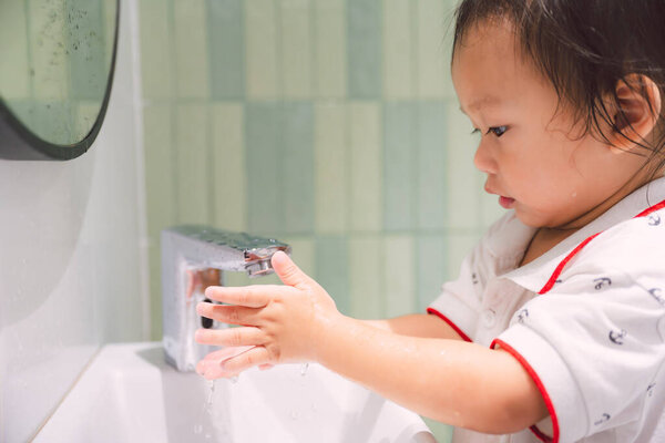 Sweet Toddler Diligently Washes Hands Sink Demonstrating Good Hygiene Habits Stock Image