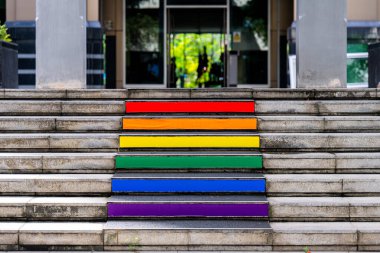 Stone steps lead up to the entrance. Anti-slip stair treads with bright colored stripes. clipart