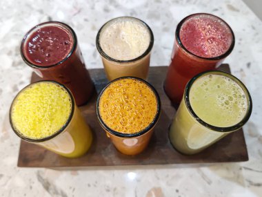 Top view of Set of tropical fruit juices in glasses at a restaurant.