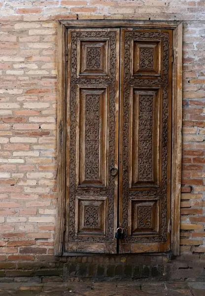 stock image traditional arabesque patterns on an ancient carved wooden door in Uzbekistan