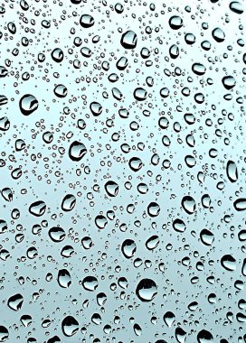 Water droplets on a glass window with a gray, overcast sky in the background. The soft reflections and muted tones create a peaceful, serene atmosphere, perfect for conveying calmness and nature. clipart