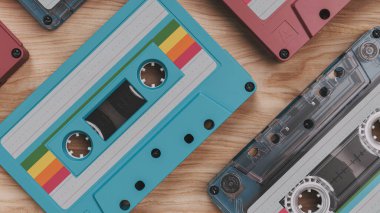 Ahşap bir yüzeye dizilmiş renkli klasik kasetlerin 3 boyutlu yorumlanması, retro müzik kavramları sergiliyor. Nostaljik ve yaratıcı çizimler için mükemmel.