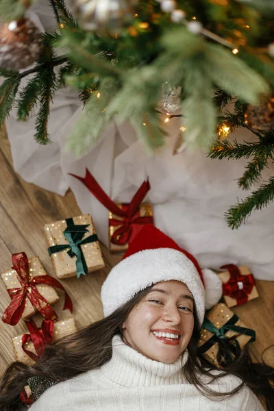 Happy Woman Santa Hat Lying Christmas Gifts Christmas Tree Top — Stock Photo, Image