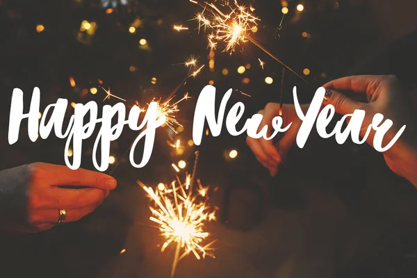 Happy New Year Text Sign Hands Holding Fireworks Christmas Lights Stock Image