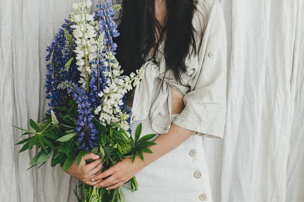 Stylish Woman Holding Lupine Bouquet Rustic Room Close Young Female — Stockfoto